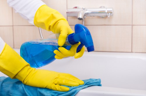 Professional cleaning of a fabric sofa with a visible stain