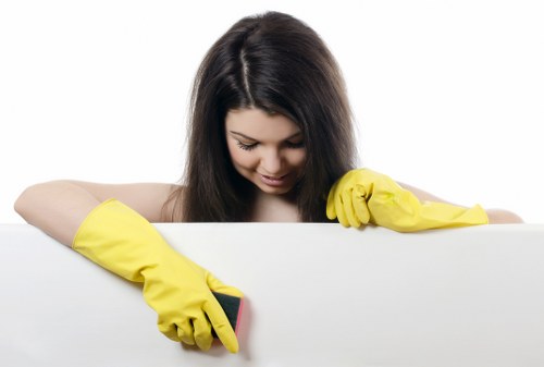 Cleaner wearing PPE while performing professional carpet cleaning in Sutton