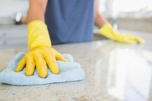 Local cleaner treating stains on a living room sofa in Sutton